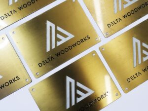 Laser Cut Brass Plaque with Brushed Surface and Countersinks for a Wood Workshop